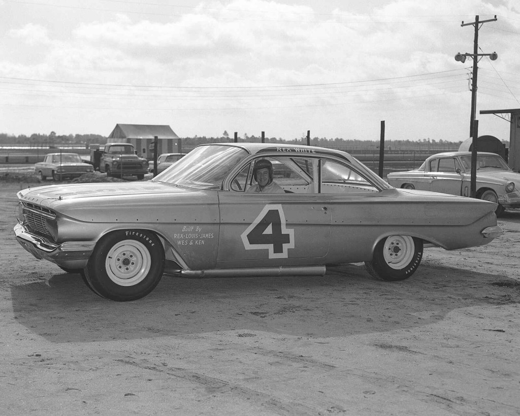 1960 NASCAR Cup champion Rex White sitting in his brand new stock 1961 Chevrolet with the number 4 painted on the left door