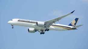 A Singapore Airlines Airbus A350 shown flying in full left profile view