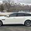 Side view of a white Jaguar station wagon.