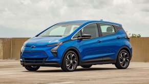 Blue 2023 Chevy Bolt EV electric vehicle posed.