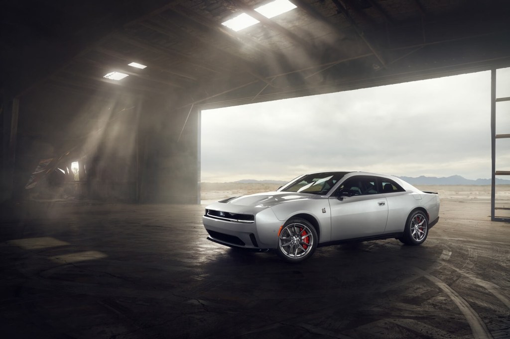 The new Dodge Charger Daytona Scat Pack shows off its styling in a hangar.