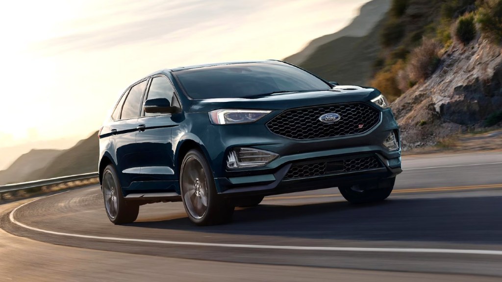 Green 2024 Ford Edge driving on a road.