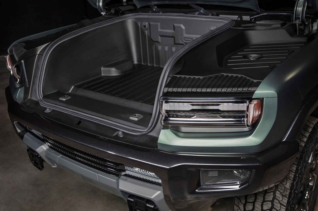 A 2024 GMC Hummer EV is shown with its front trunk, "frunk," open in close view