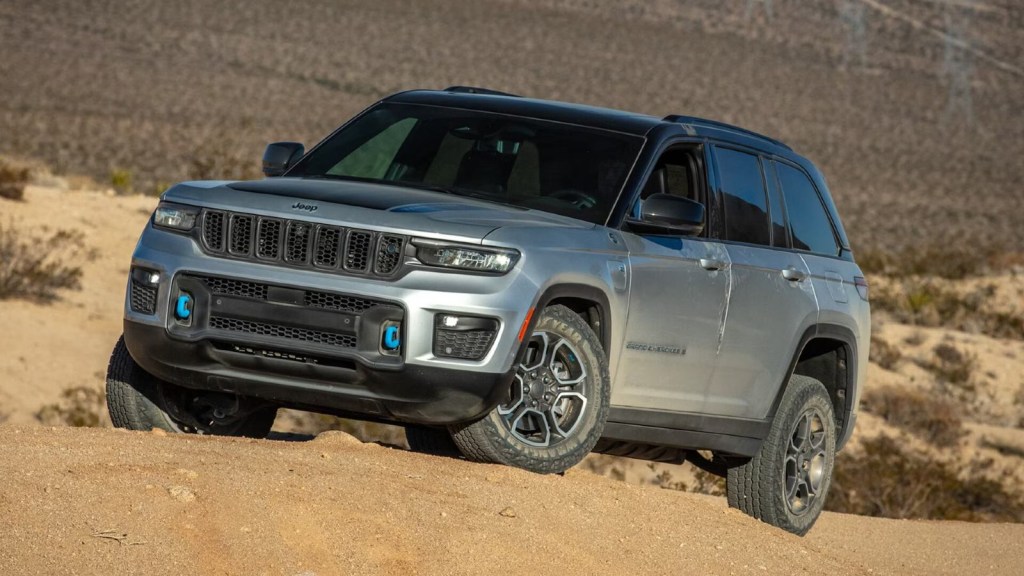 2024 Jeep Grand Cherokee 4xe climbing a dirt hill.