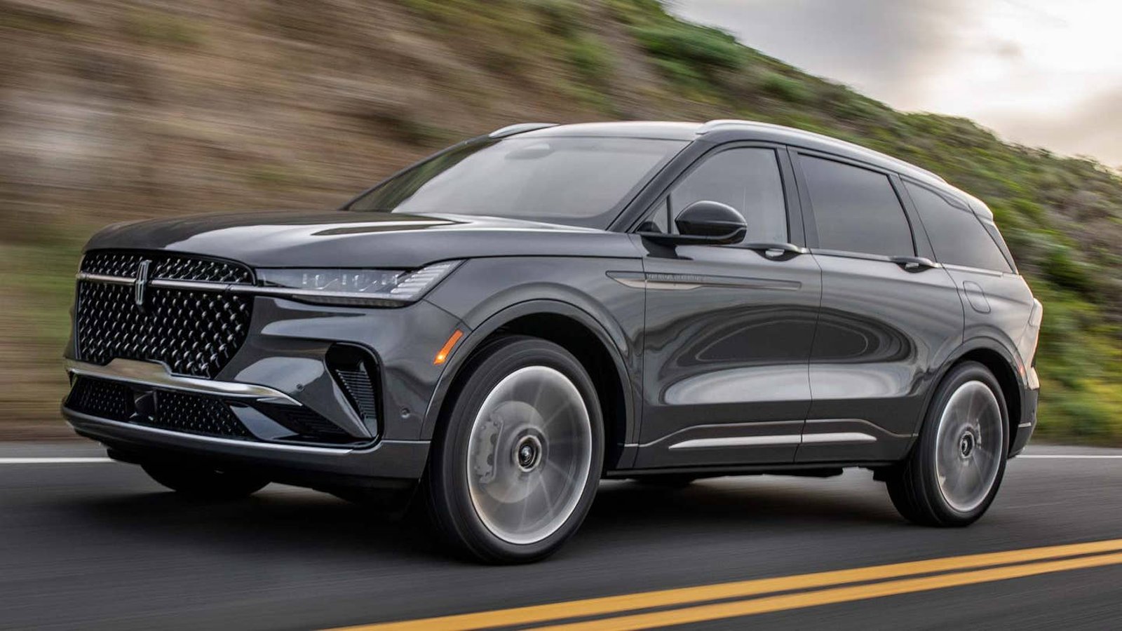 Gray 2024 Lincoln Nautilus luxury SUV driving on a road.