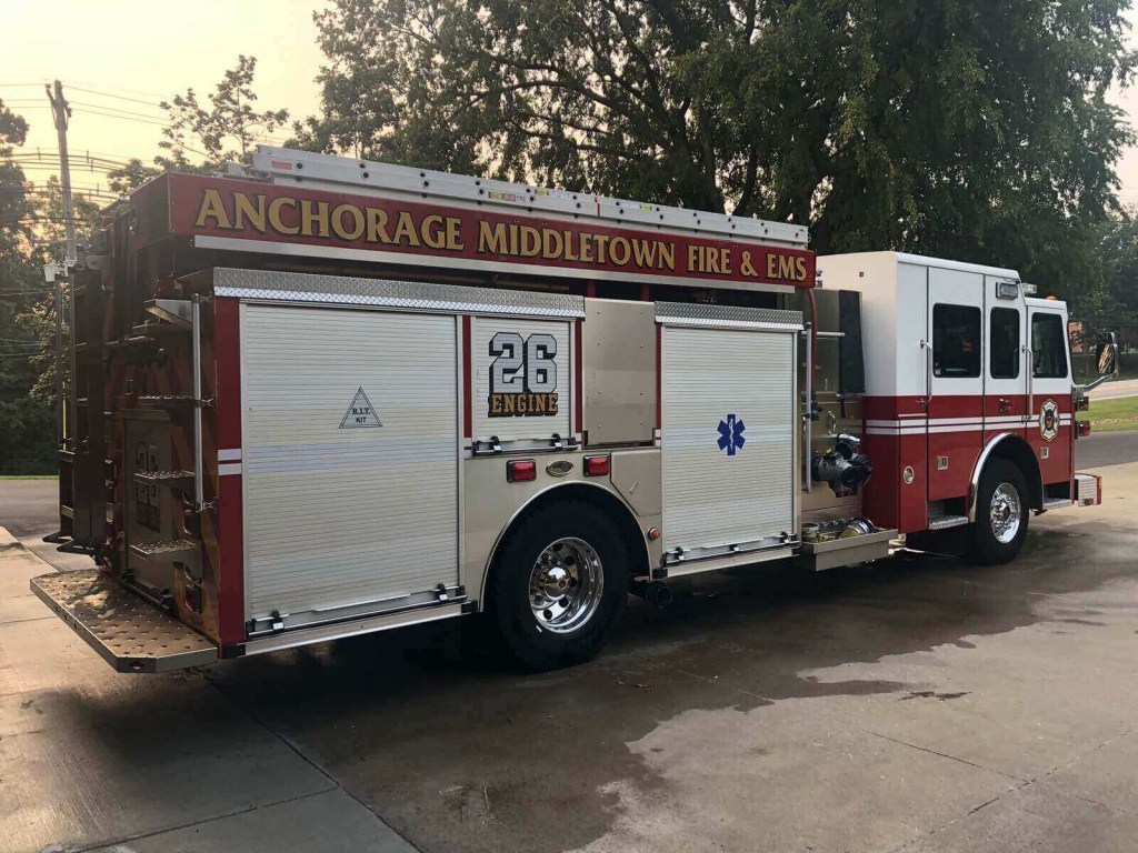 A fire engine shows off its side profile.