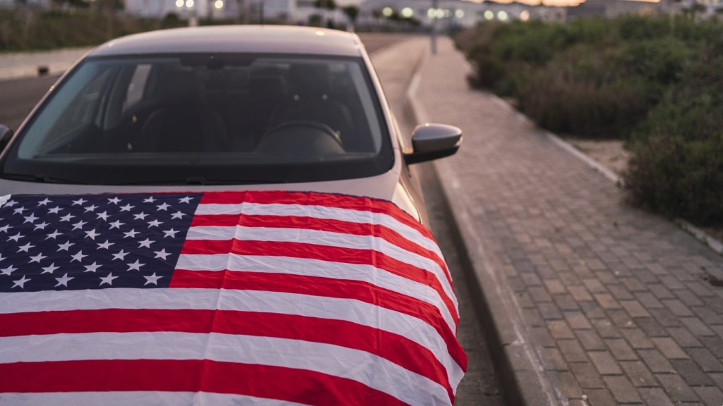 American Flag Draped Over the Hood of a Car