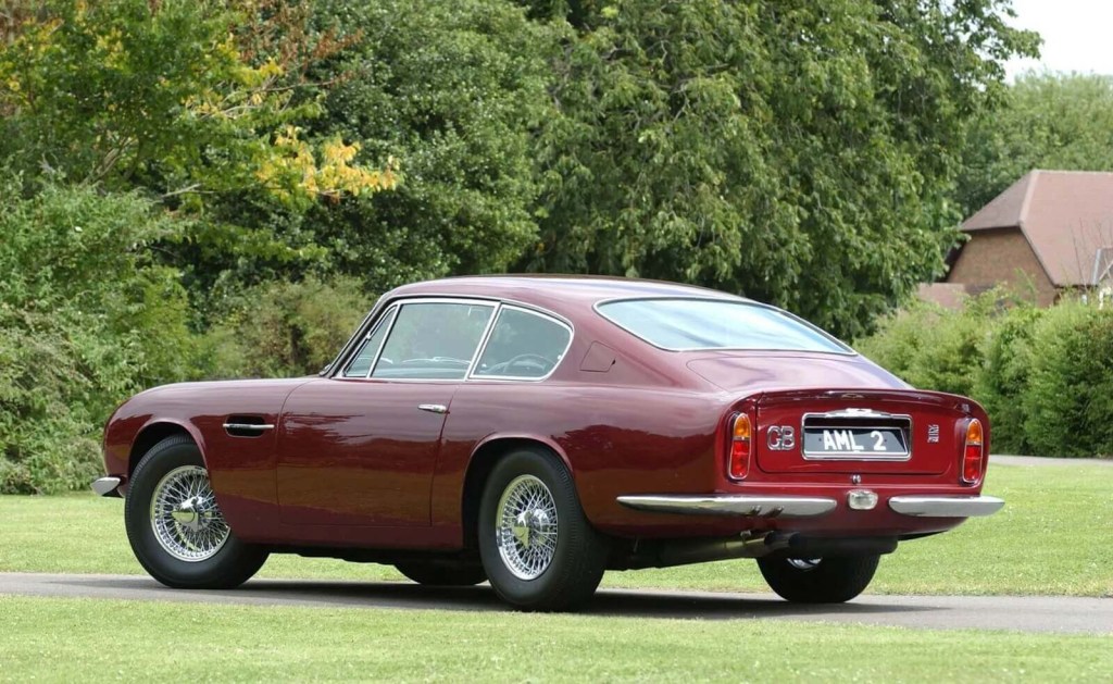 A red Aston Martin DB6 shows off its rear-end styling.