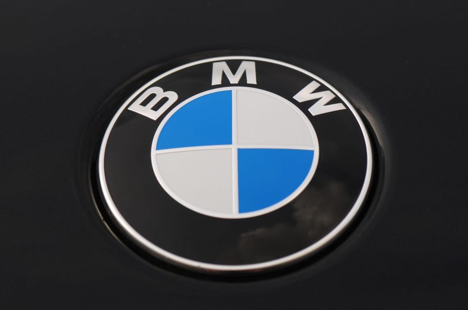 A BMW badge, the symbol that builds brand loyalty among its owners, displays its colors.