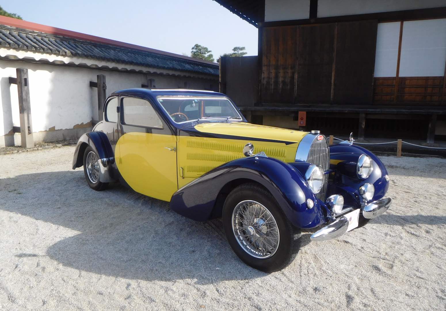 Yellow and blue Bugatti Grand Touring coupe.