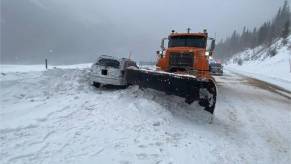A police chase ends with a snowplow driving into a Jeep Grand Cherokee.