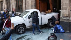 A Chevy Silverado being used by protestors to break through doors