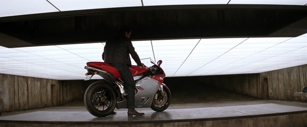 Christian Bale as 'Batman', not unlike Angelina Jolie in "Gone in 60 Seconds," sits on an MV Agusta F4.