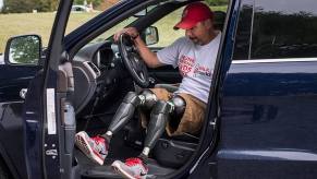 Retired Army Sgt. Maj. Jeremy Bruns, a double amputee, gets into his car to drive without legs.