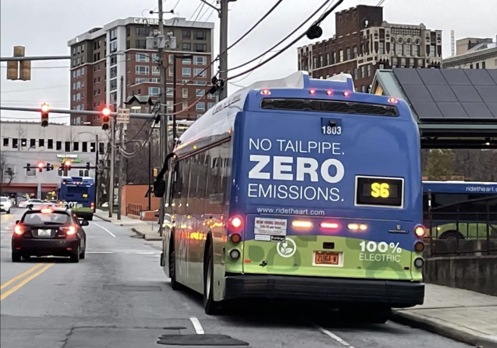 An electric bus in city traffic around Asheville, NC