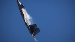 A F-22 Raptor noses up in-flight.