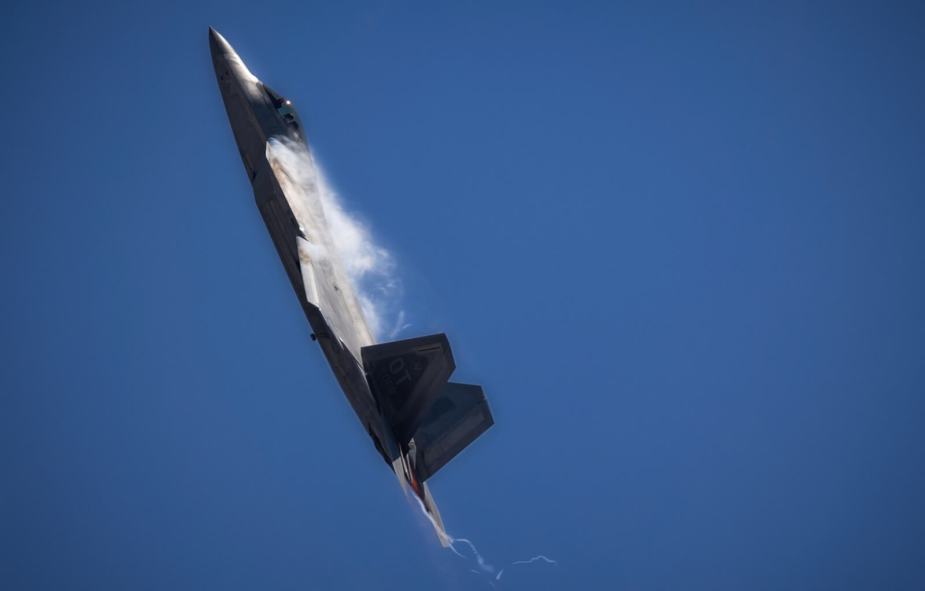 A F-22 Raptor noses up in-flight.