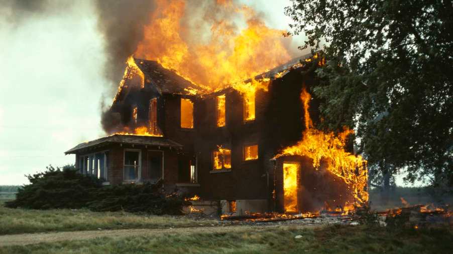 Yellow and orange flames demolish a suburban home.