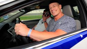 John Cena, the voice of Honda car commercials, sits in a race car.