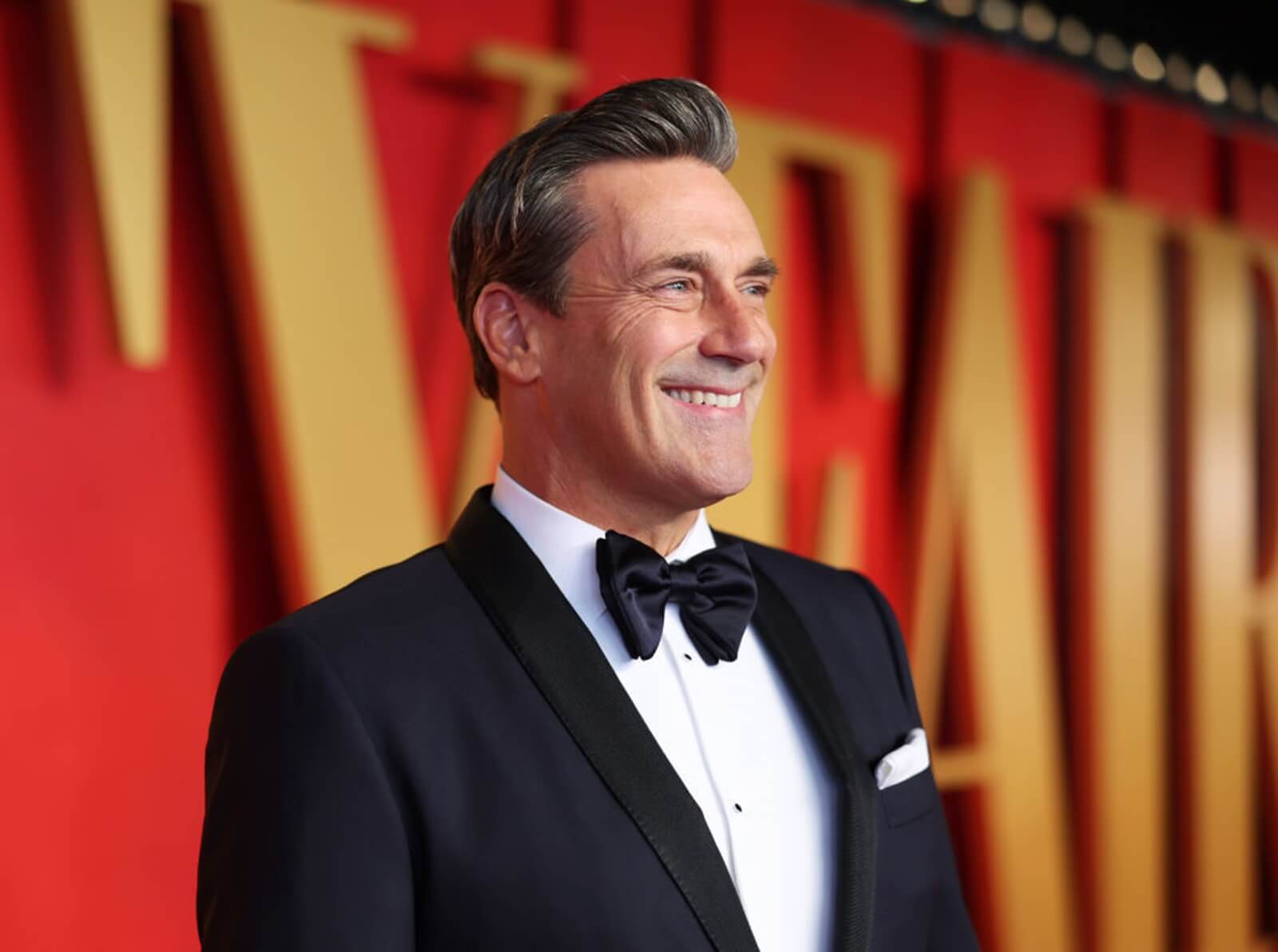 Jon Hamm smiles at an award show. 