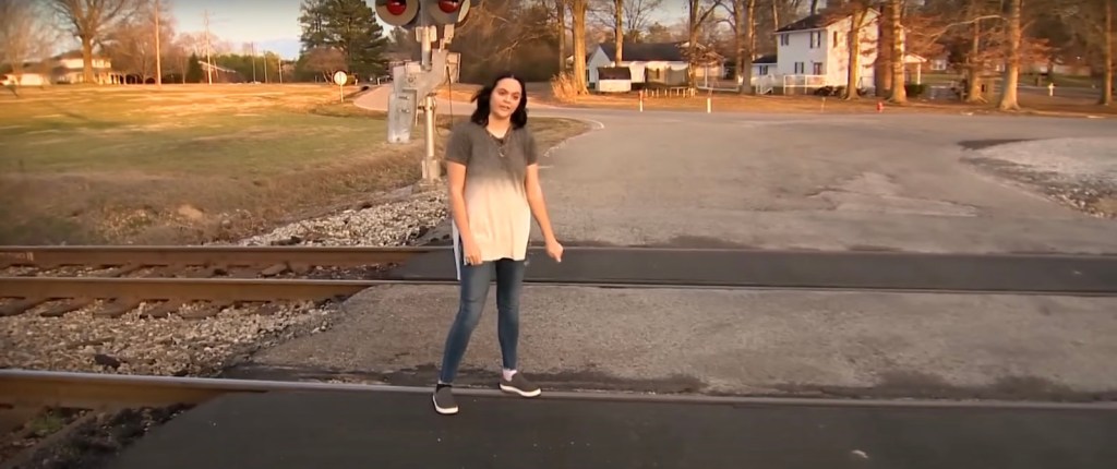 18-year-old girl on the tracks where she saved a wheelchair-bound woman from an oncoming train.