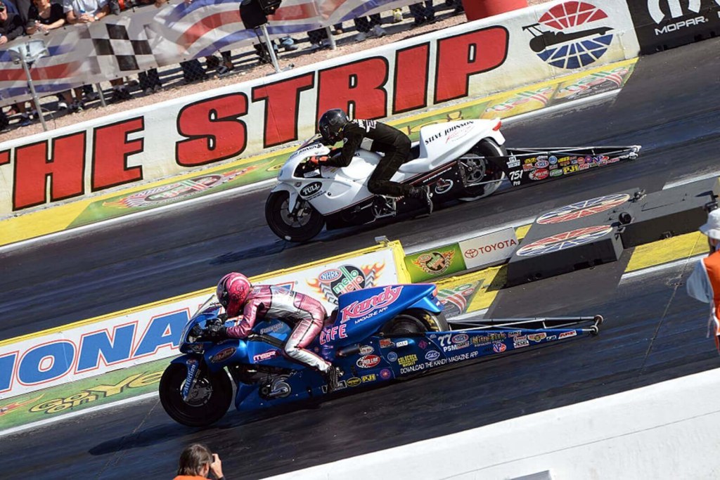 A NHRA Pro Stock Motorcycle Racing riders on stretched motorcycles designed to drag race. 