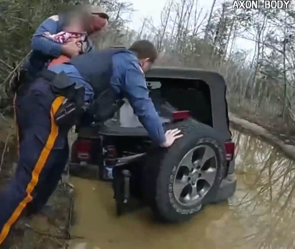 A set of Jersey Shore Police Officers pull a baby out of a submerged Jeep Wrangler. 