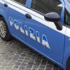 The side of an Italian police car marked with the word 'Polizia'.