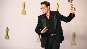 Actor Robert Downey Jr. posing with his oscar, 2024