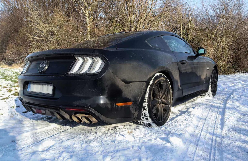 A black S550 Ford Mustang GT in Germany shows off its integrated amber turn signals and brake light combination. 