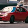 A red 2006 Subaru Impreza WRX slides in Baby Driver.