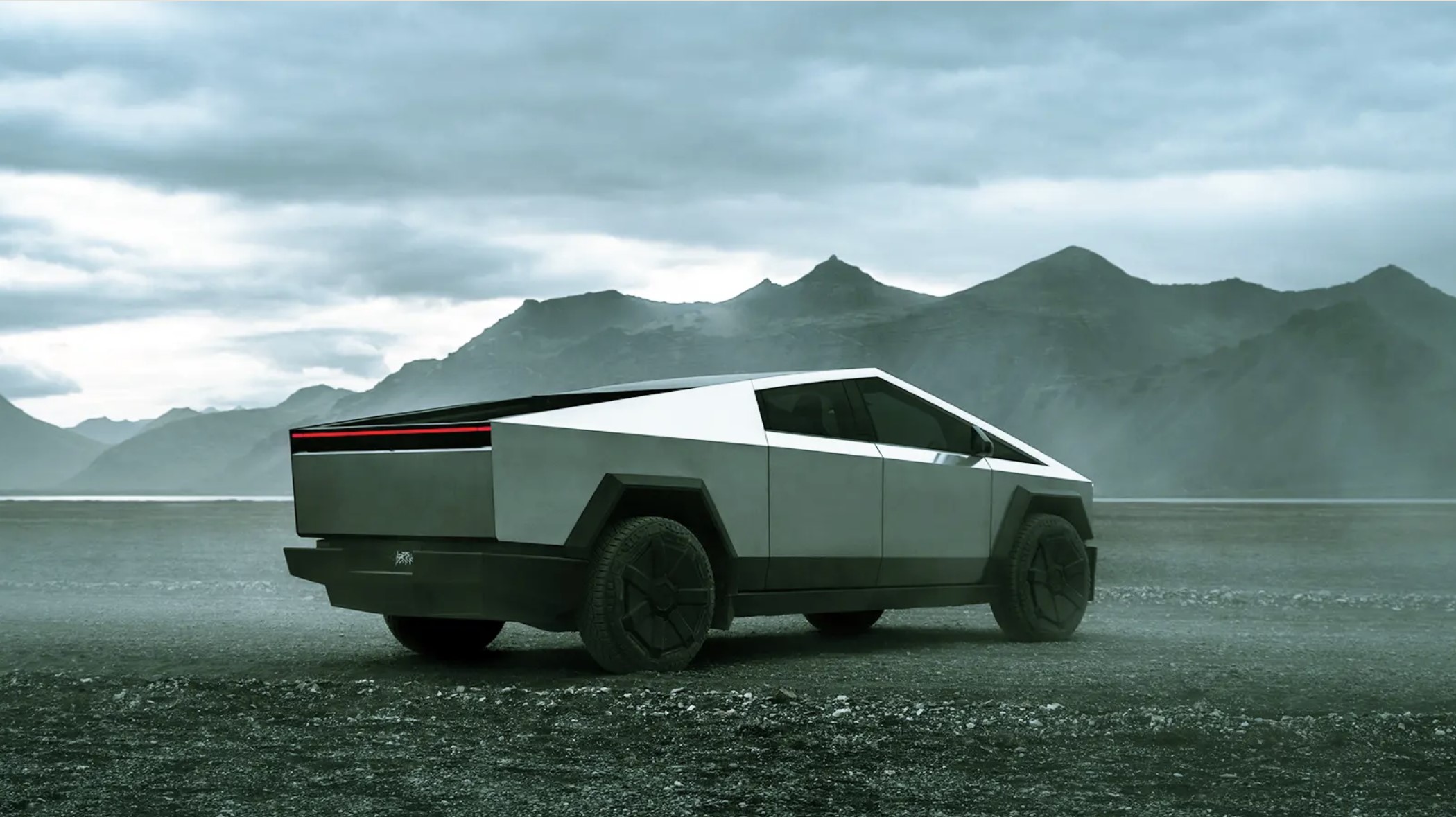 The Tesla Cybertruck driving through gravel