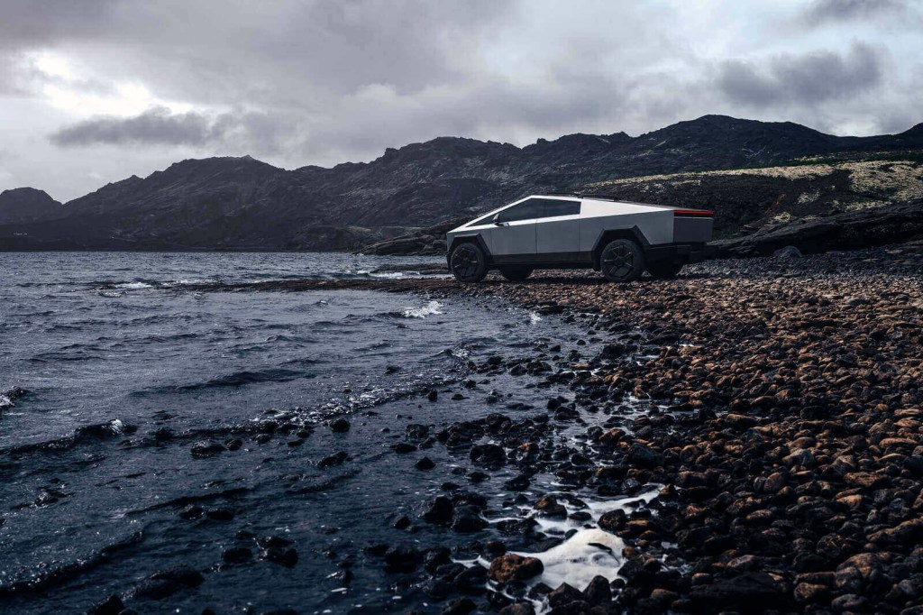 A Tesla Cybertruck parks by the water. 