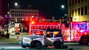 A silver Jeep Wrangler is a totaled car after an accident.