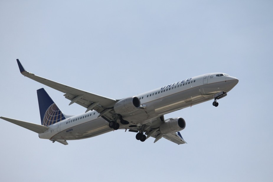 A United Airlines Boeing 737-900 lands at an airport.