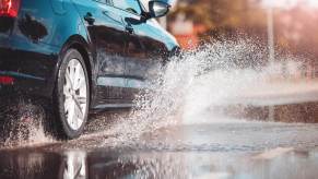 A Volkswagen sedan displaces water to avoid hydroplaning or aquaplaning.