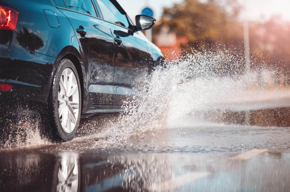 A Volkswagen sedan displaces water to avoid hydroplaning or aquaplaning.