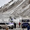 Several SUVs and a commercial truck parked at Everest Base Camp North in Tibet