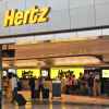 A Hertz rental car storefront in an airport