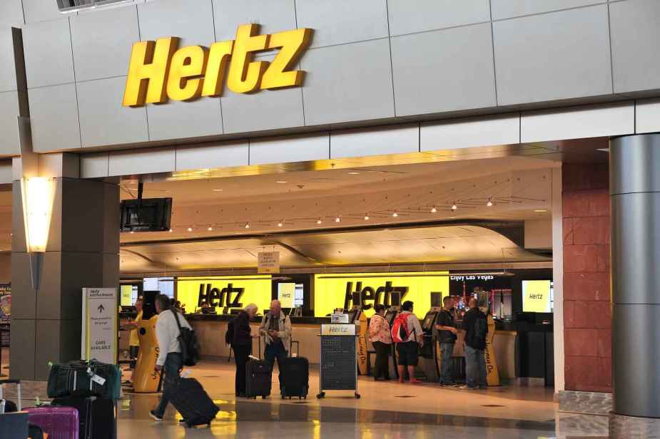 A Hertz rental car storefront in an airport
