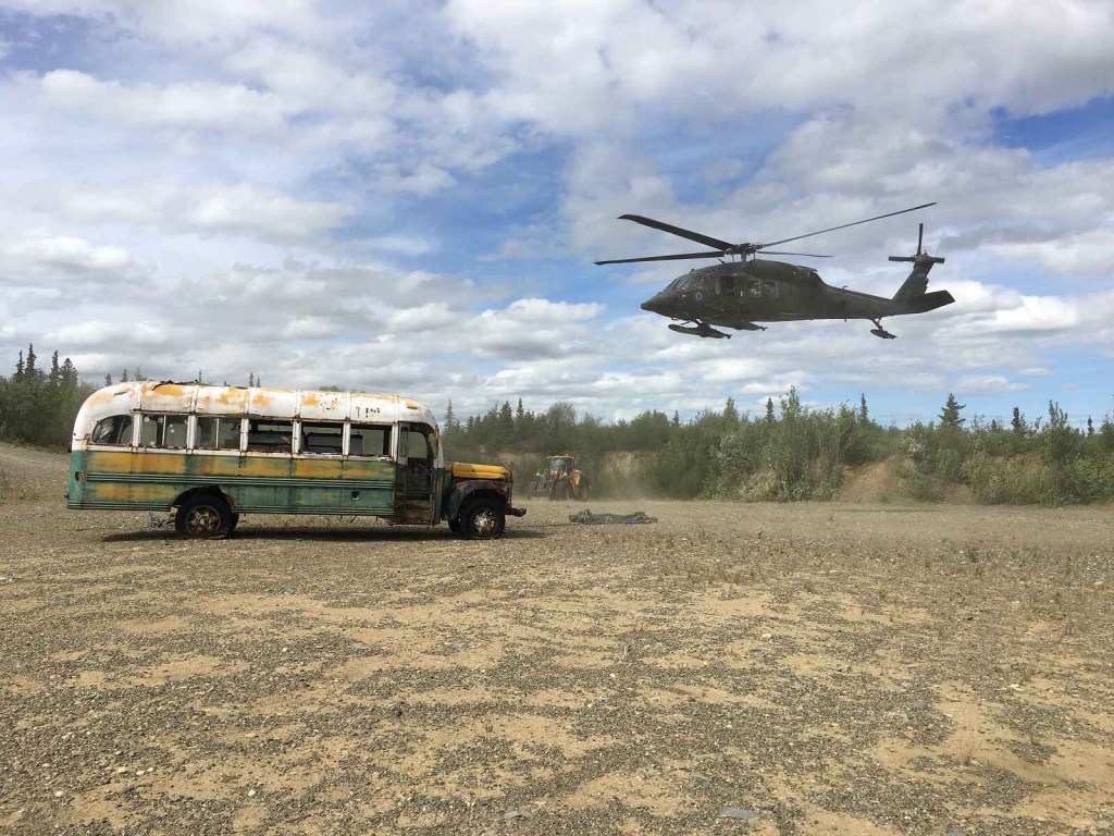 A national guard helicopter is shown hovering above Bus 142, the 1946 International Harvester Chris McCandless lived in until his death in August 1993
