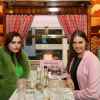 Charli Howard and Amber Le Bon sit in the British train carriage redesigned by Wes Anderson