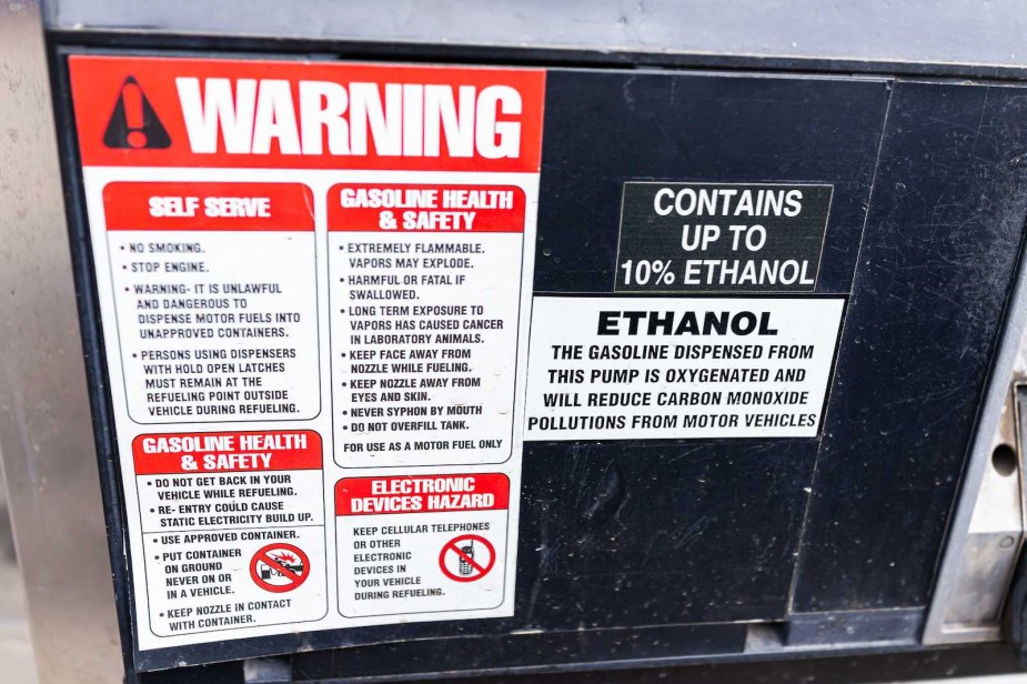 Sign warning of up to 10% ethanol fuel mixture on a gasoline pump.