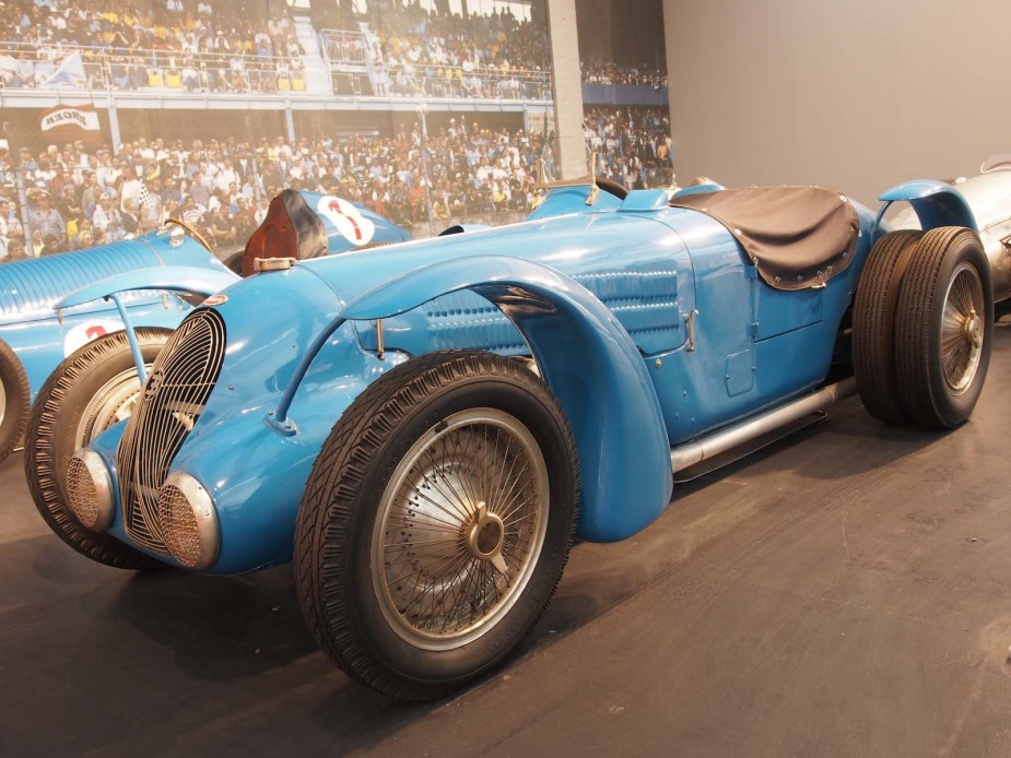 Blue Bugatti Grand Prix race car parked in a museum