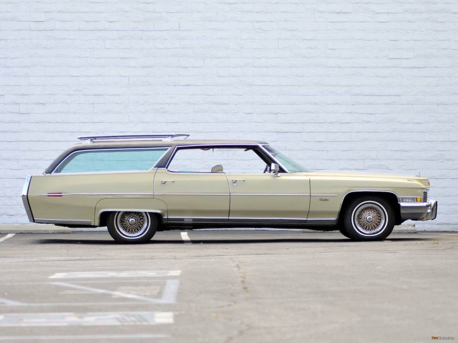 Custom Cadillac station wagon sitting in front of a white wall.