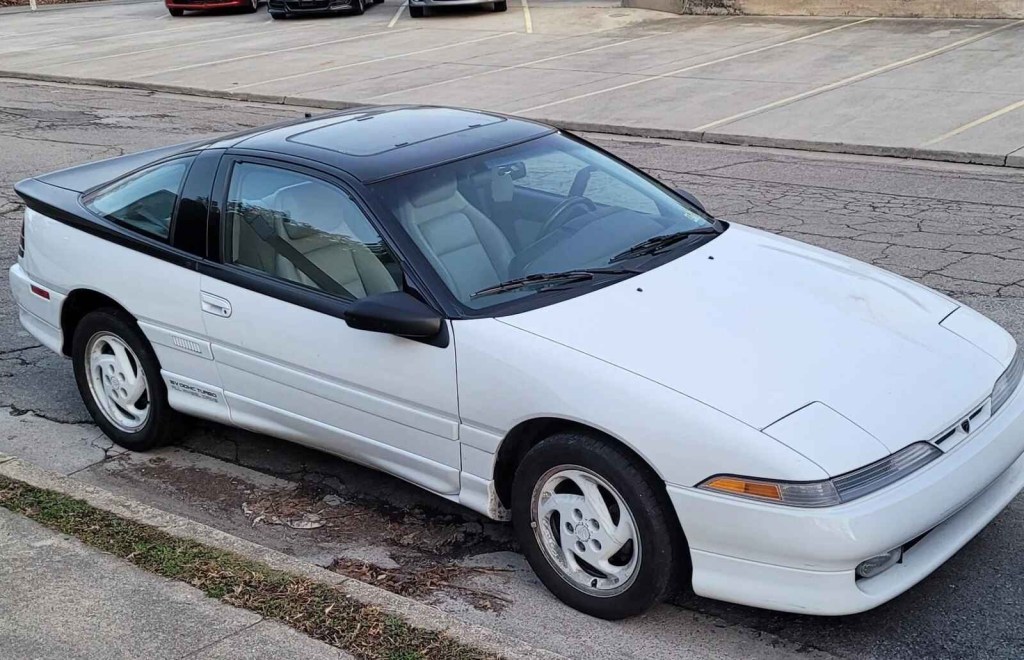 A white 1990 Eagle Talon parked on street in right front profile view