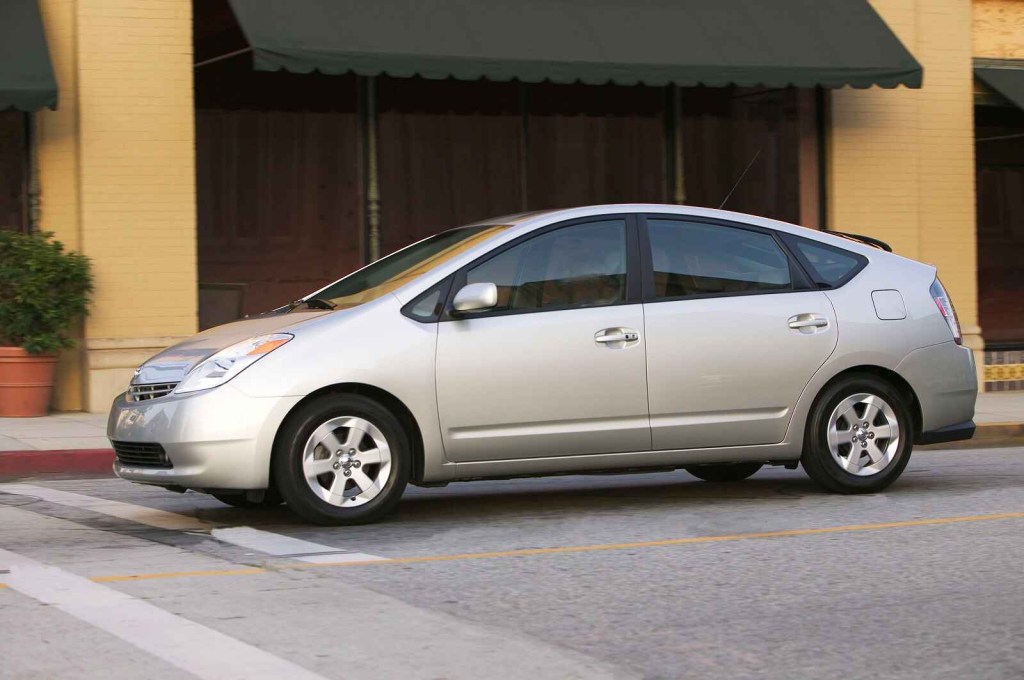 A silver 2004 Toyota Prius is parked on a clean city street in left front profile view