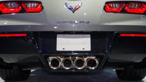 The four exhaust tailpipes in the rear bumper of a Chevrolet Corvette sports car.