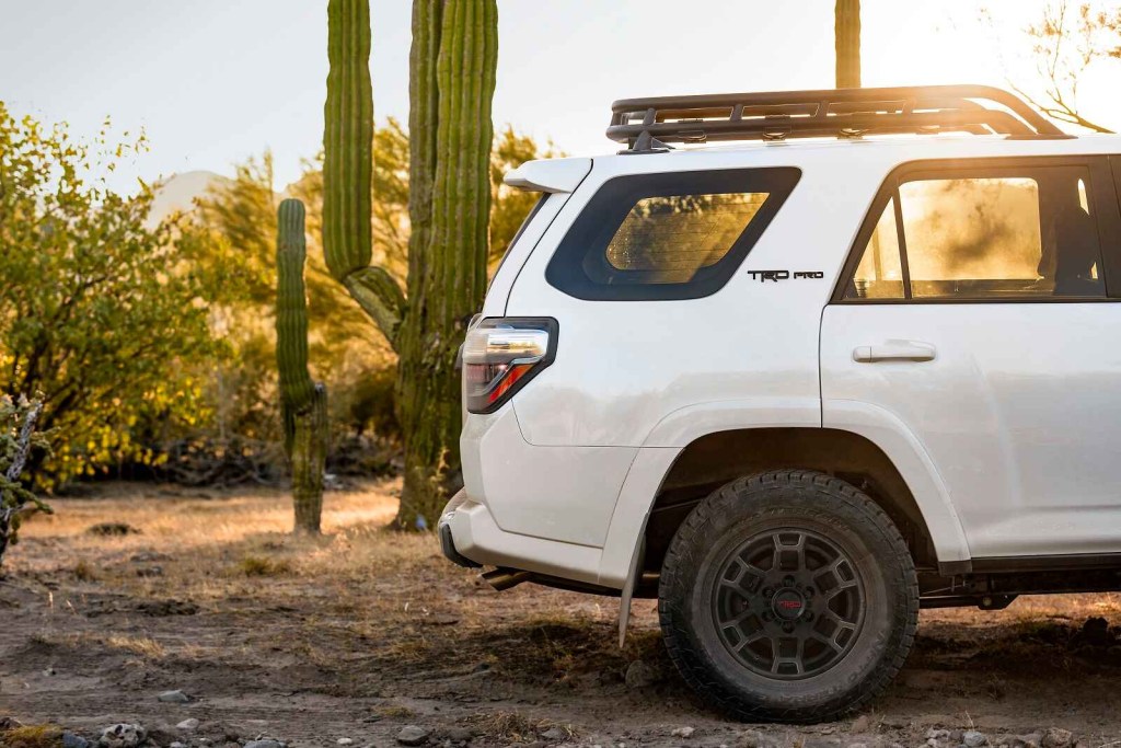 A white 2021 Toyota 4Runner TRD Pro shown in right profile view desert landscape showing half the SUV