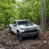 The 2024 Chevy Silverado 1500 off-roading in the woods